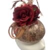 Rose gold sequinned headpiece with burgundy flowers & feather detail to finish.