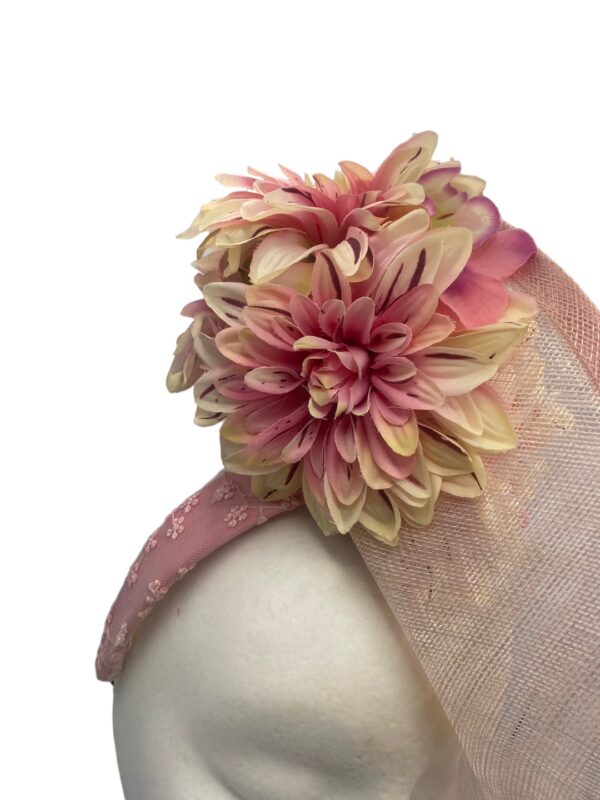 Pink side saucer headpiece on a headband with stunning flower detail.