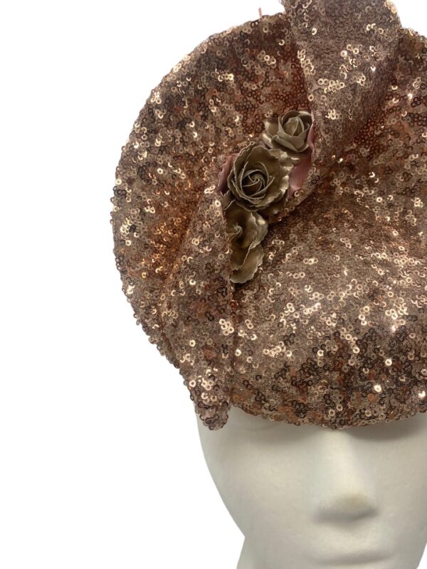 Rose gold sequinned percher headpiece with swirl detail to the top.