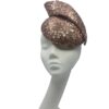 Rose gold sequinned headpiece with swirl detail to the top and rose gold leather Dior flowers to the back of the swirl.