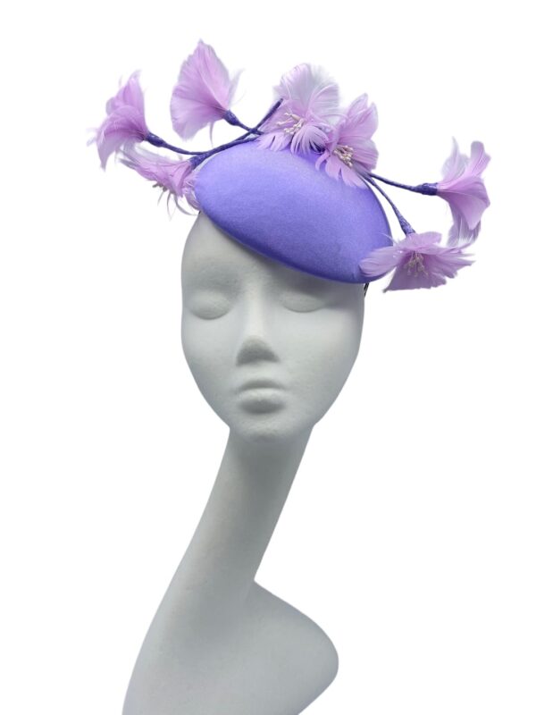 Fabulous lilac headpiece with quirky baby pink flower detail.