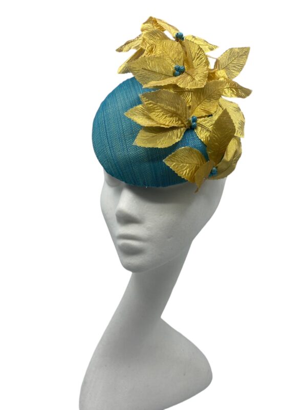 Teal hat with gold flowers with teal bead centre piece.