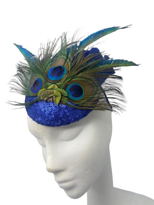 Blue sequinned headpiece on a headband with stunning peacock feather detail.