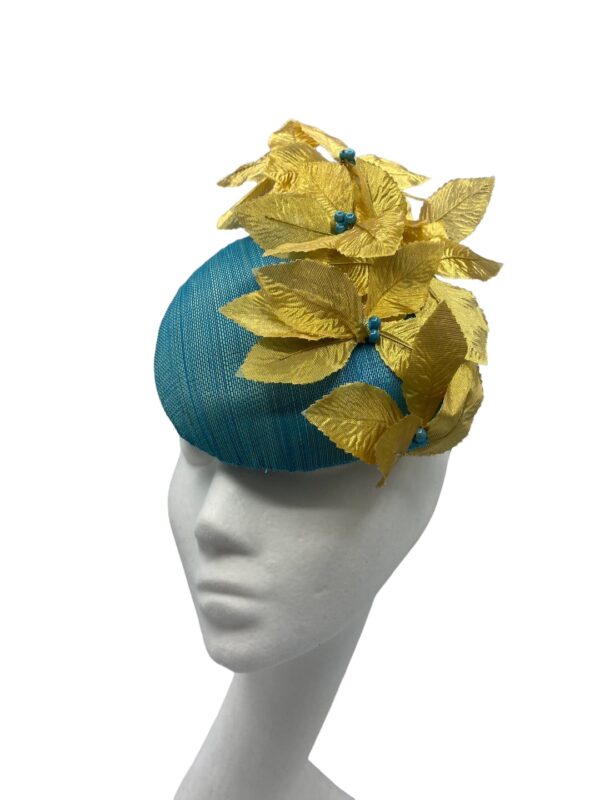 Teal hat with gold flowers with teal bead centre piece.