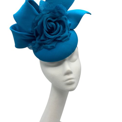 Stunning teal side bow headpiece with flower detail.