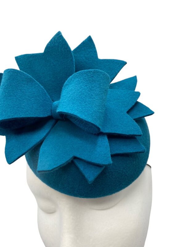 Stunning teal felt small headpiece with simple detail to finish.