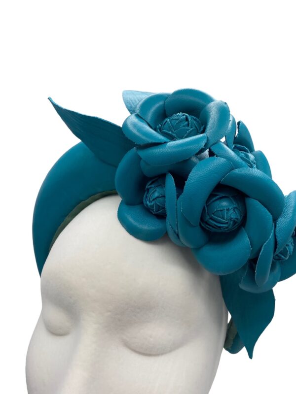 Teal leather crown with leather flower detail.