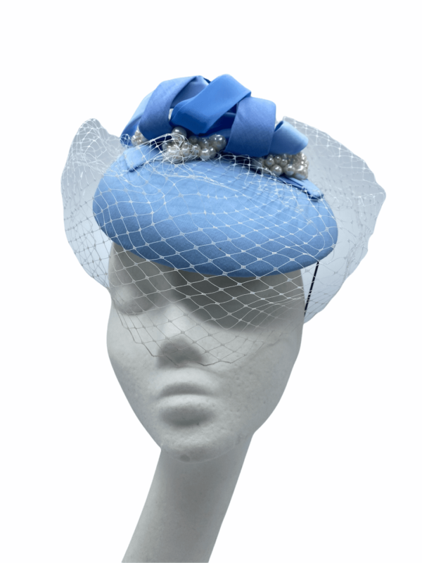 Stunning baby blue headpiece with white  face veiling overlay. This headpiece also has a number of different blue swirls on the top to tie in multiple blue tones.